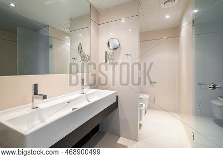 Large Bathroom Is Divided Into Zones With Large Square Full Length Mirror And Rectangular Sink With 