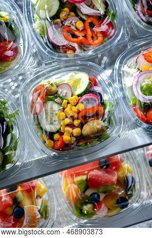 Plastic Boxes With Pre-packaged Vegetable Salads, Put Up For Sale In A Commercial Refrigerator