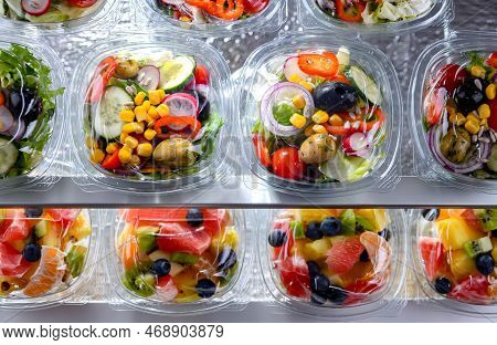 Plastic Boxes With Pre-packaged Vegetable Salads, Put Up For Sale In A Commercial Refrigerator