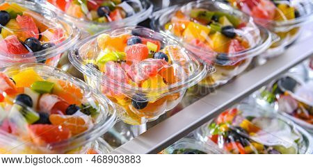 Boxes With Pre-packaged Fruit Salads In A Commercial Fridge