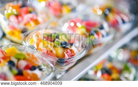 Boxes With Pre-packaged Fruit Salads In A Commercial Fridge
