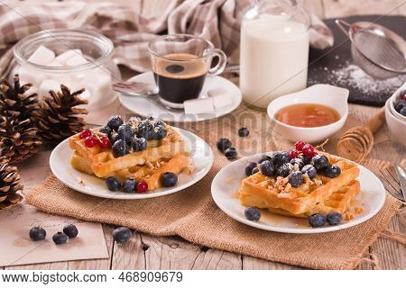 Waffles With Red Currant And Blueberries On White Dish.