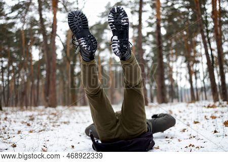 Young Man Slipped And Lost His Balance During A Walk On A Birch Grove In Winter.