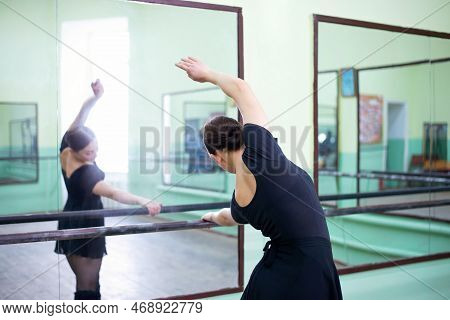 Female Professional Dancer Preparing A New Performance In Dancing Hall Near The Mirror. Dancing Prac