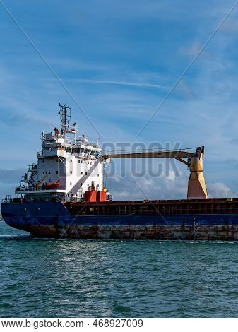 Cobh, Ireland, August 10, 2022. An Old Rusty Big Ship Is Sailing On The Sea, Blue Sky. Cargo Ship On