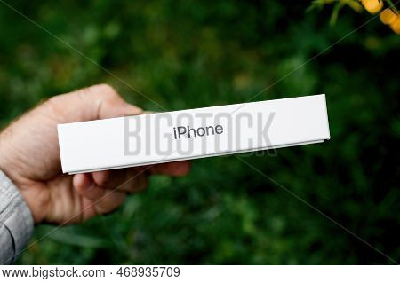 London, United Kingdom - Sept 28, 2022: Pov Male Hand Holding Package Of The Latest Iphone 14 Pro Pr