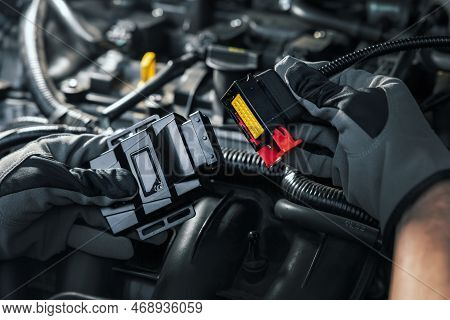 Mechanic Installing Chip Tuning Box On Car Engine