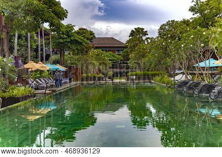 Indonesia, Bali, Seminyak, November, 2022: Swimming Pool With Clear Turquoise Water Surrounded By A 