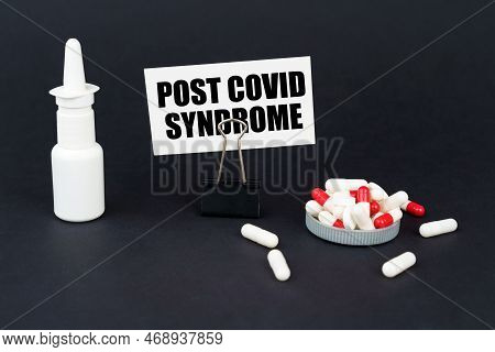 Medical Concept. On The Black Surface Of A Pill, A Nasal Spray And A Business Card On An Office Pape
