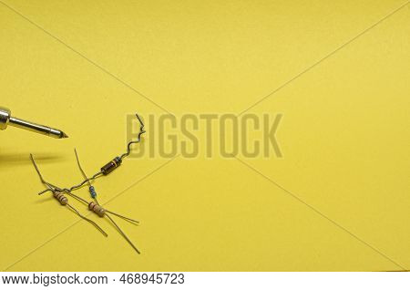Four Resistors In The Lower Left Corner Of A Yellow Background