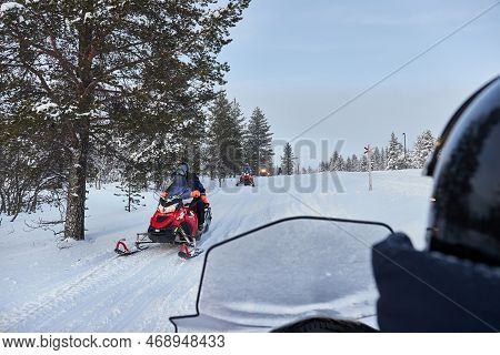Riding On A Snowmobile In Finland, Traffic Near A Lapland Village
