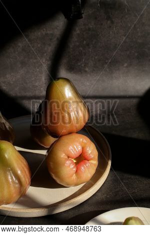Rose Apple Or Jambu On Dark Background Under Sunlight. Thailand Apple Tropical Fruit Flavors Of Swee