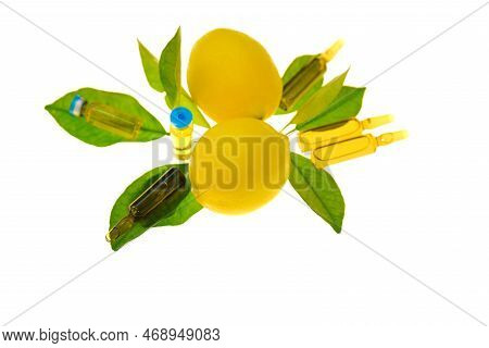 Vitamin C Ampoules.solution Of Vitamin C, Lemons Fruits With Leaves On A White Background .injection