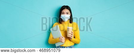 Covid-19, Social Distancing And Pandemic Concept. Worried Asian Woman In Medical Mask, Frowning Sad,