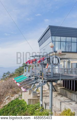 Hadong-gun, South Korea; November 24, 2022: Four Zip-line Tension Control Units On Platform Under Cl