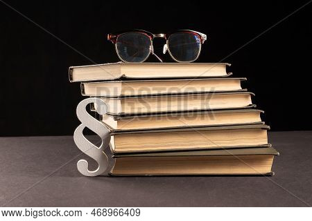Sign Paragraph Glasses And Books On Black Stone Background