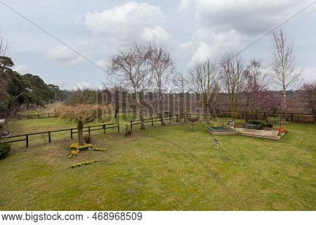 Kennett, Suffolk, England - March 1 2019: Landcaped Grounds And Gardens With Patio And Expansive Law