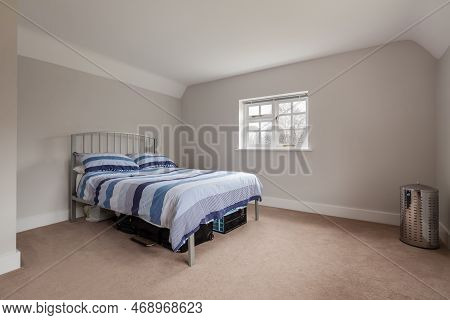 Kennett, Suffolk, England - March 1 2019: Sparsely Furnished Bedroom Including Metal Framed Bed With