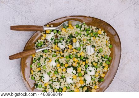 Salad Of Vegetables, Pasta And Mozzarella In A Dish On A Light Background. Top View.
