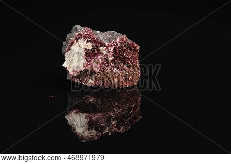 Closeup Photo Of Raw Crimson Erythrite Mineral Gemstone On Black Background With Reflection