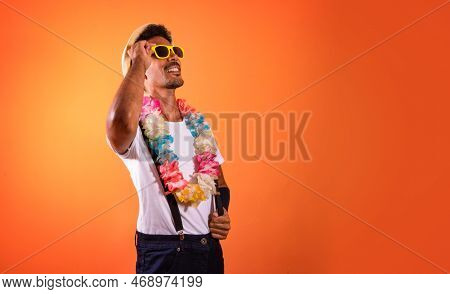 Portrait Of Black Man With Carnival Props Isolated On Orange Background.