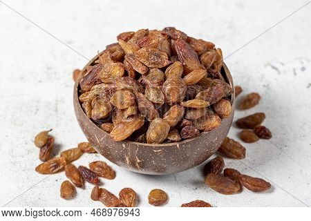 Dried apricots on stone background. Dark dried apricots in a glass bowl. Diet foods. close up