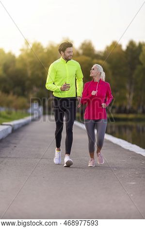 Running Concepts. Urban Sports - Couple Jogging For Fitness In The City On A Beautiful Autumn Day