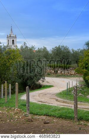 Ruins Of The Old Roman City Of Conimbriga In Portugal With A Medieval Church In The Background