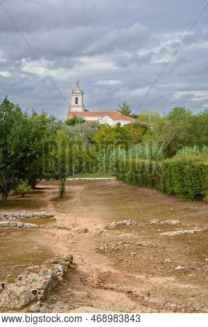 Ruins Of The Old Roman City Of Conimbriga In Portugal With A Medieval Church In The Background