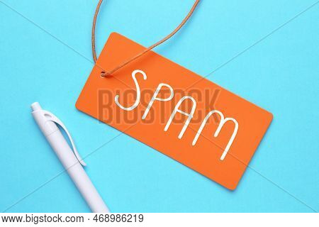 Spam Word In Paper Card On Blue Background. Business Concept.