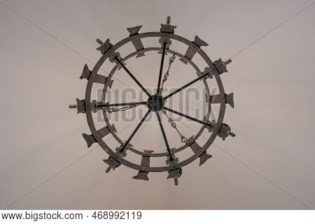 Medieval Style Chandelier Glows Bright While Hanging Over Head