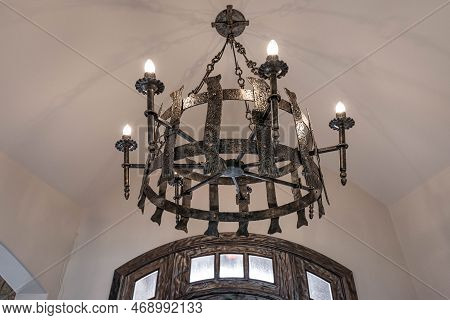 Medieval Style Chandelier Glows Bright While Hanging Over Head