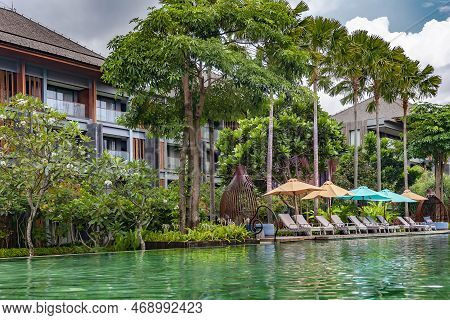 Indonesia, Bali, Seminyak, November, 2022: Swimming Pool With Clear Turquoise Water Surrounded By A 