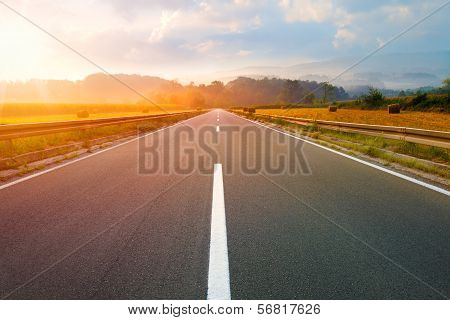 Driving On An Empty Road At Dawn