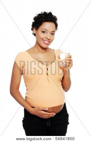 Pregnant woman with glass of water , isolated on white 