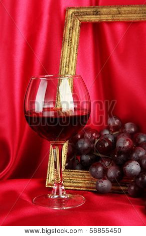 composition of frame,wine and grapes on bright background