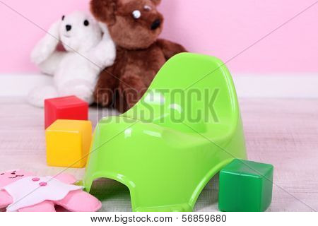 Green potty on home interior background