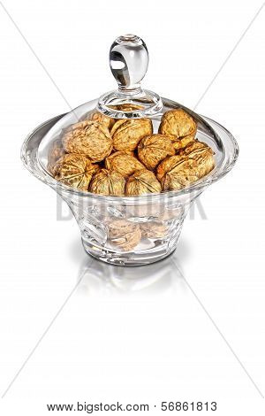 Nutmegs In Glass Jar On White Background