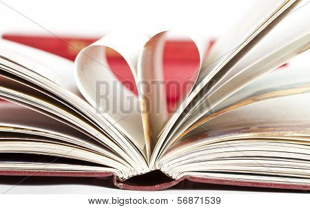 Close up on heart shaped book pages 