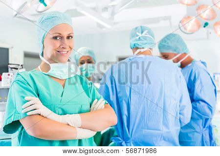 Hospital - surgery team in the operating room or Op of a clinic operating on a patient in emergency