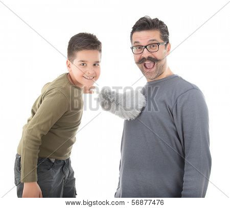 Little boy dusting his father with feather duster isolated on white background  