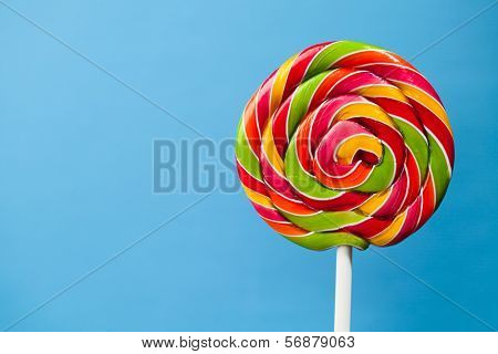 colorful lollipop candy on blue background