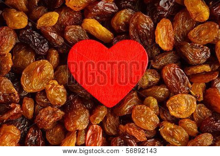 Diet Healthy Food. Raisin As Background Texture And Red Heart