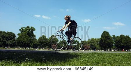 Young woman is cycling in a park