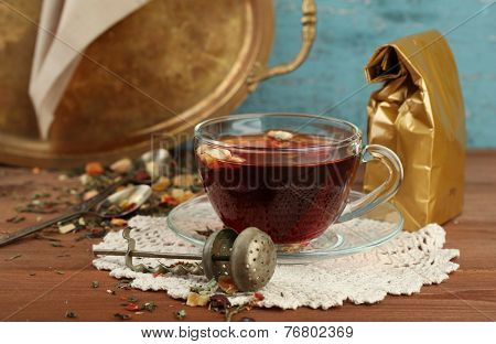 Beautiful vintage composition with herbal tea, on wooden table