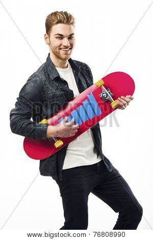 Studio portrait of a young man posing with a skateboard