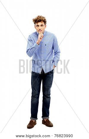 Young man making silence gesture, shhhhh!!