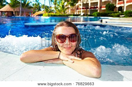Woman relaxing in jacuzzi. Vacation at caribbean resort.