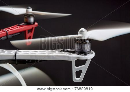 rotating propellers of a hexacopter drone against black background
