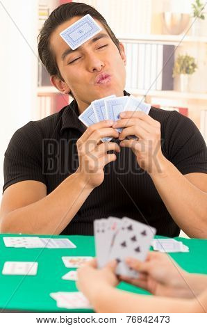 young man playing cards cuarenta traditional Ecuadorian game